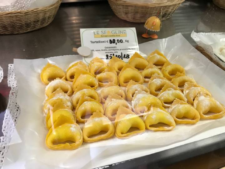 Tortelloni on display in a pasta shop